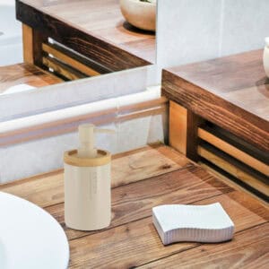 Beige dispenser blending into a rustic wooden bathroom decor