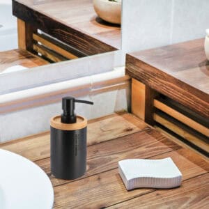 Black dispenser blending into a rustic wooden bathroom decor