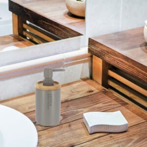 Gray dispenser blending into a rustic wooden bathroom decor