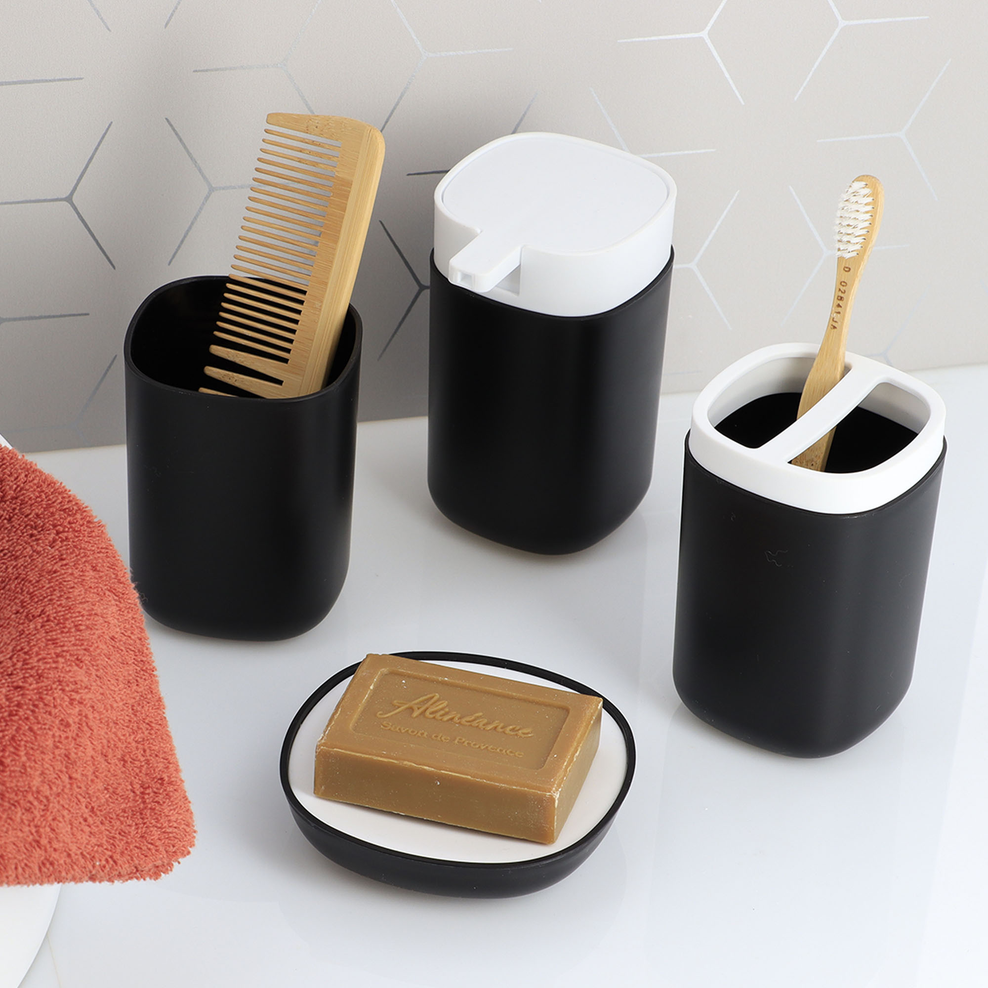 Black bathroom organizers holding comb, toothbrush, and soap