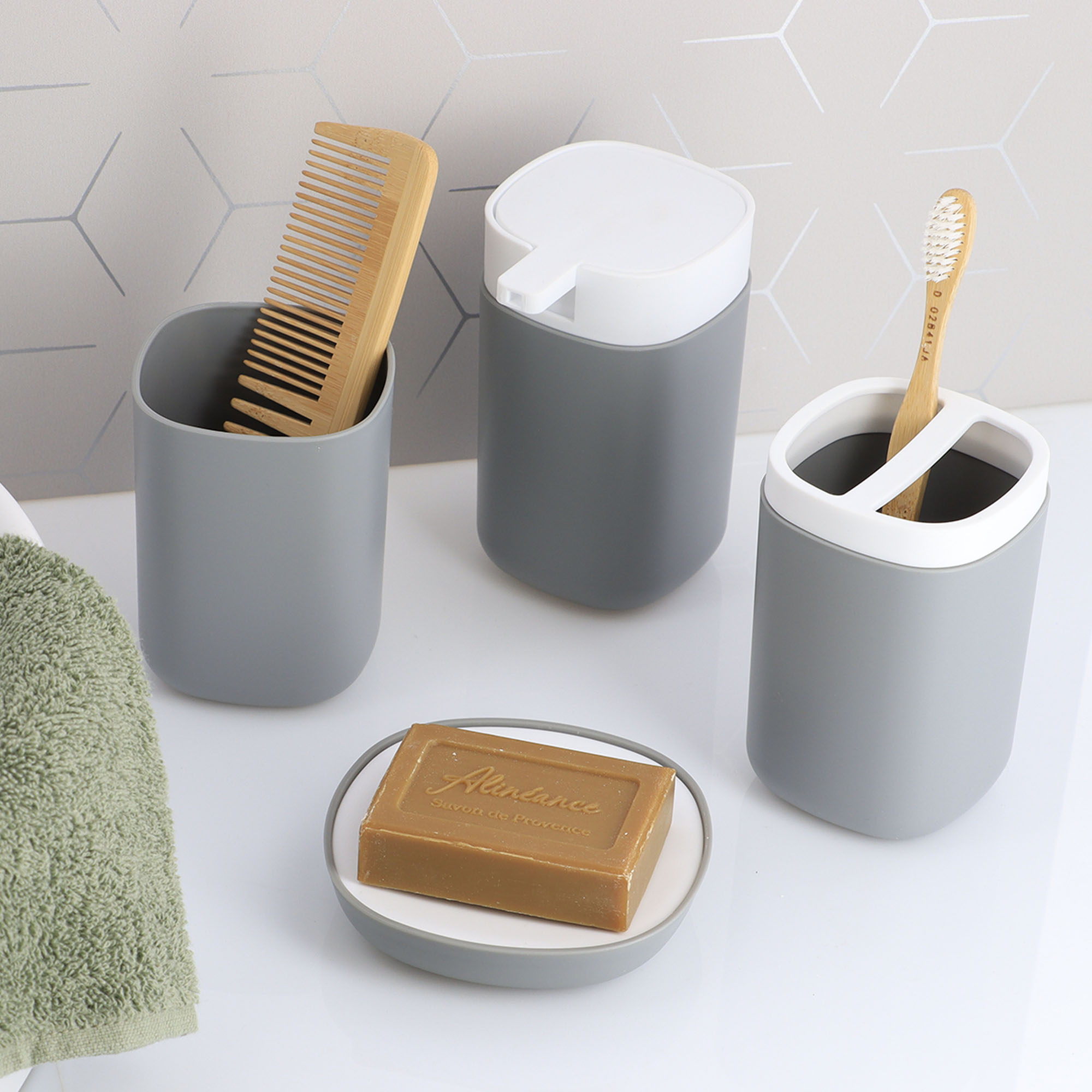 Gray bathroom organizers holding comb, toothbrush, and soap