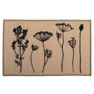 Natural beige floral kitchen mat with black botanical stem print of wildflowers and seed heads displayed flat against a warm tan background.