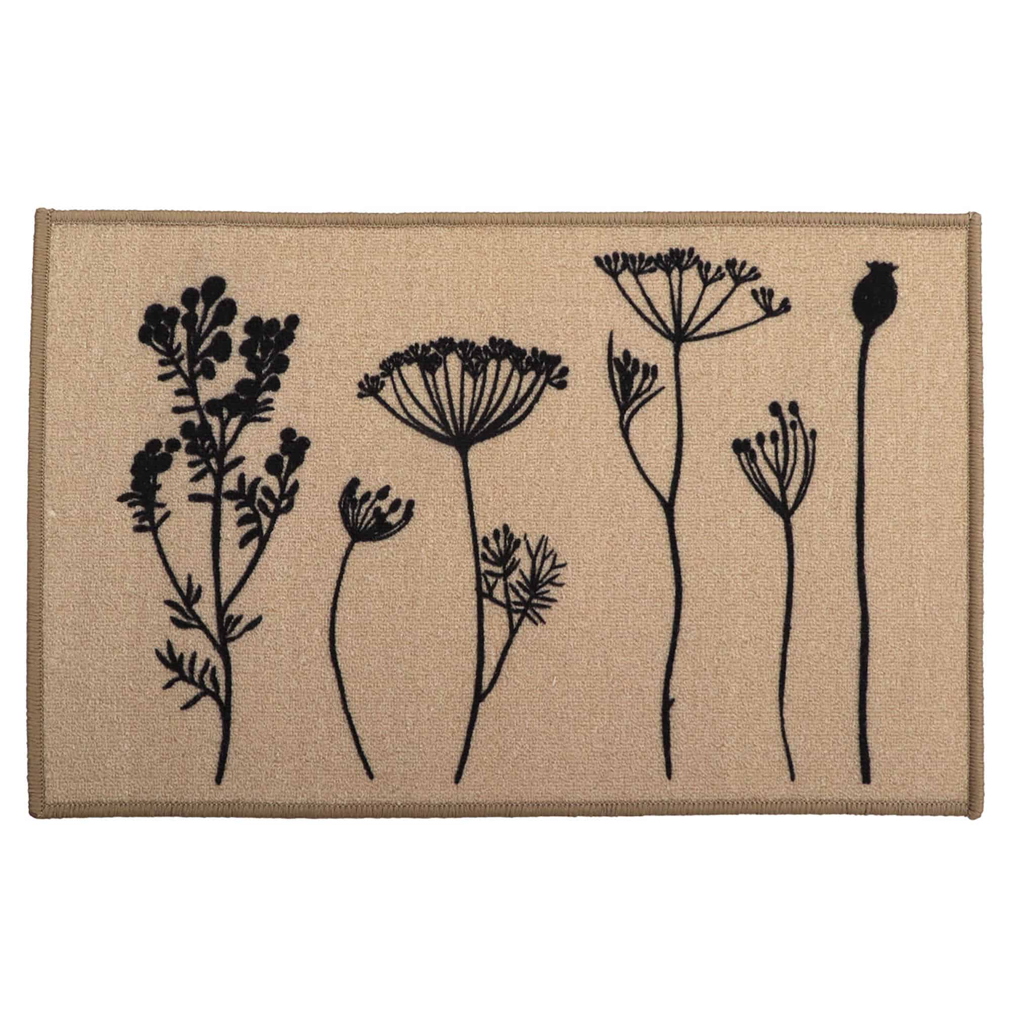 Natural beige floral kitchen mat with black botanical stem print of wildflowers and seed heads displayed flat against a warm tan background.