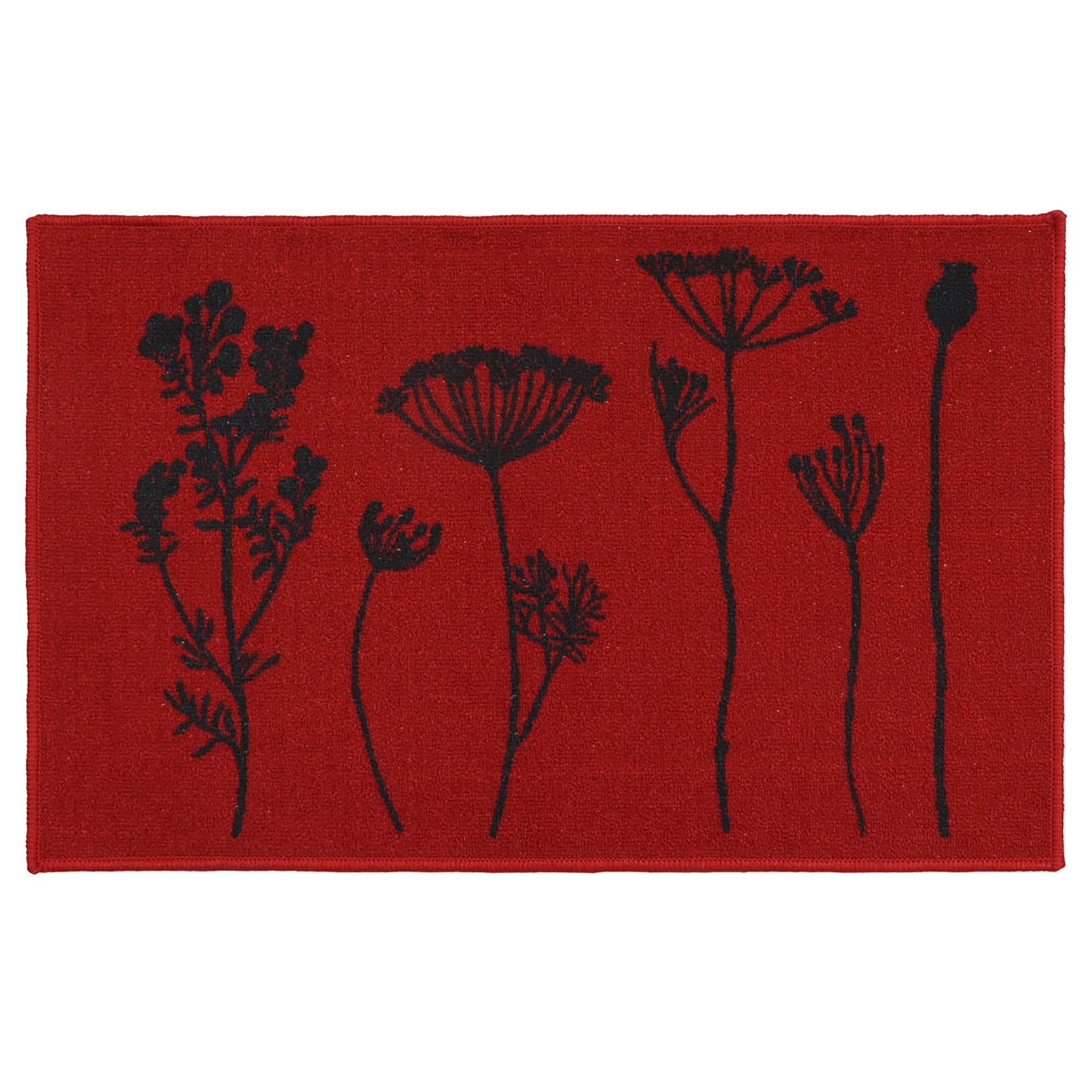 Red floral kitchen mat with black botanical stem print of wildflowers and seed heads displayed flat against a deep red background.