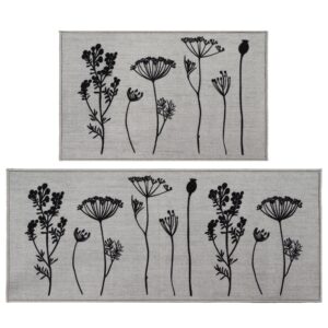 Two piece floral kitchen rug set in gray with black wildflower and seed head silhouettes, a mat and a longer runner shown flat on white.