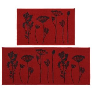 Two piece floral kitchen rug set in red with black wildflower and seed head silhouettes, a mat and a longer runner shown flat on white.