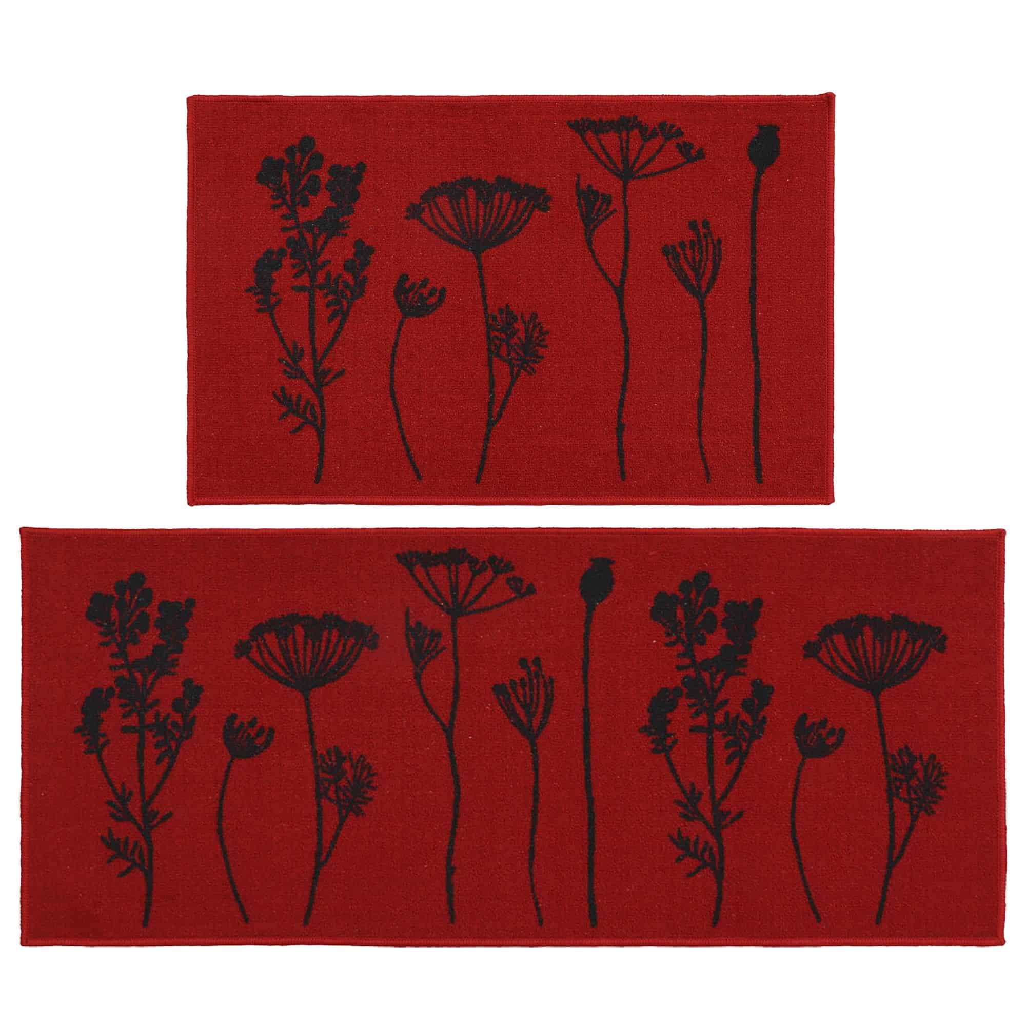 Two piece floral kitchen rug set in red with black wildflower and seed head silhouettes, a mat and a longer runner shown flat on white.