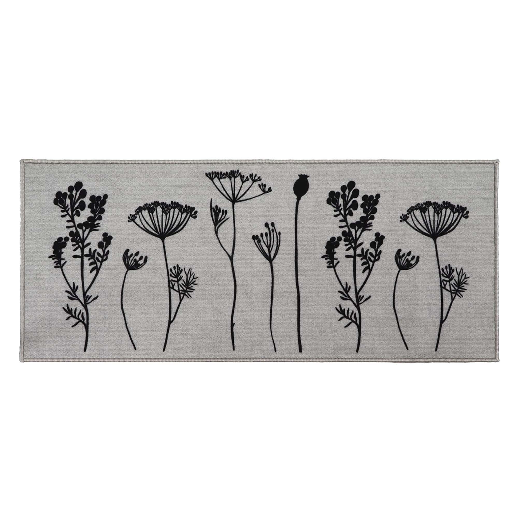 Gray floral kitchen runner rug with black botanical stem print of wildflowers and seed heads displayed flat against a soft gray background.