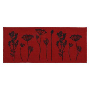 Red floral kitchen runner rug with black botanical stem print of wildflowers and seed heads displayed flat against a deep red background.