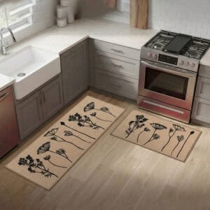 Natural beige floral mat and runner set on hardwood beside a farmhouse sink and stove, black botanical stems warming a bright modern kitchen.