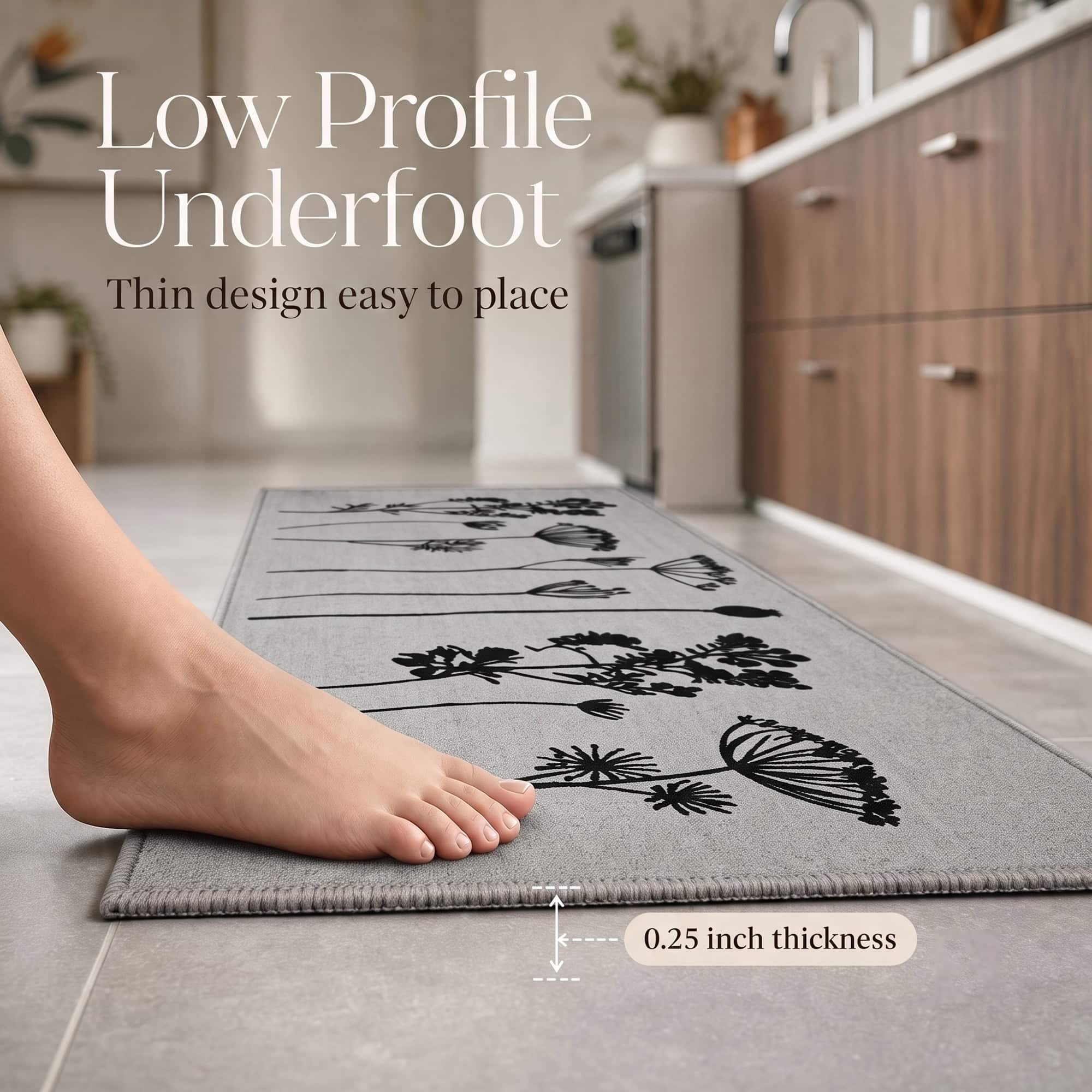 Bare foot resting on a gray low profile kitchen runner with a callout noting the thin quarter inch thickness that is easy to place.