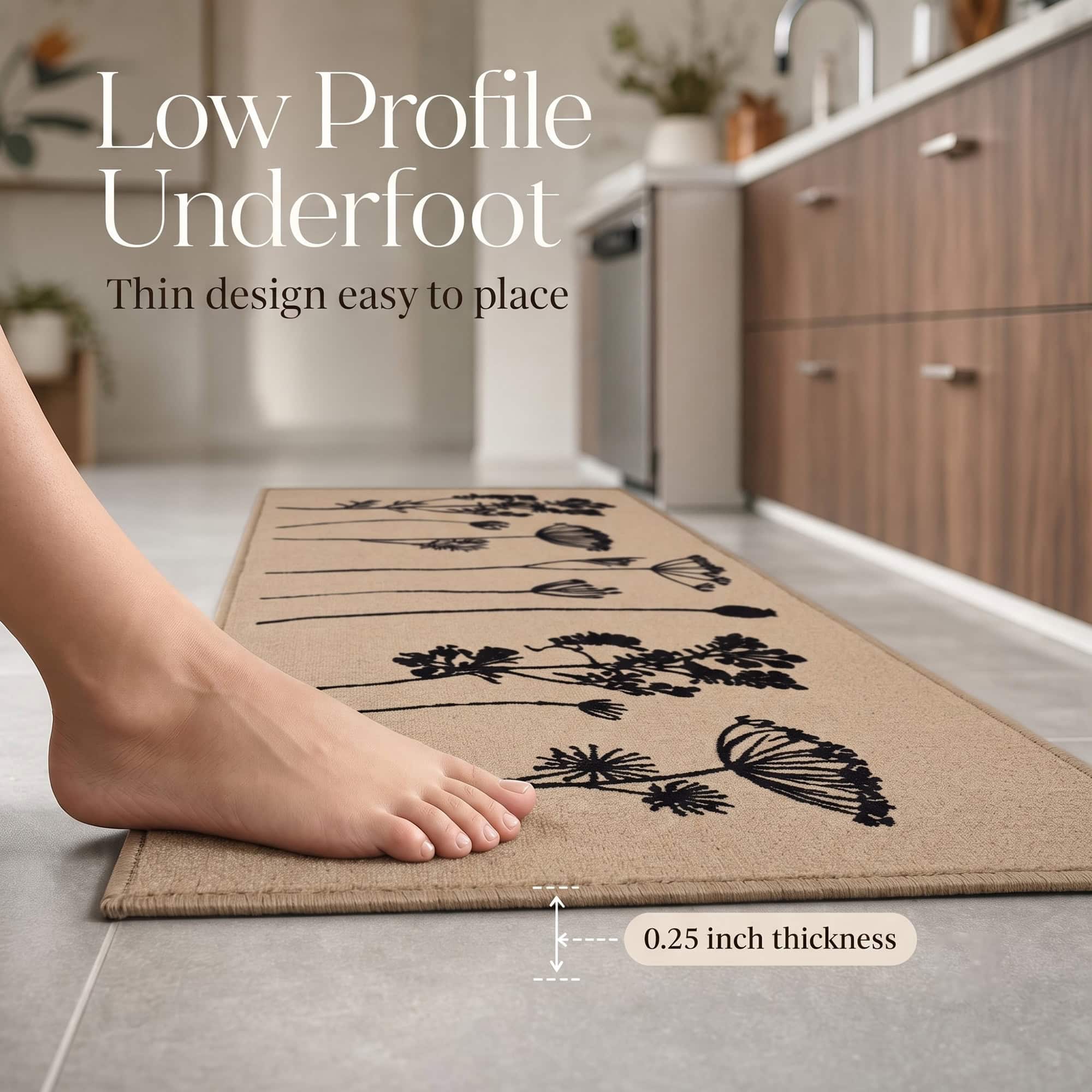 Bare foot resting on a natural beige low profile kitchen runner with a callout noting the thin quarter inch thickness that is easy to place.