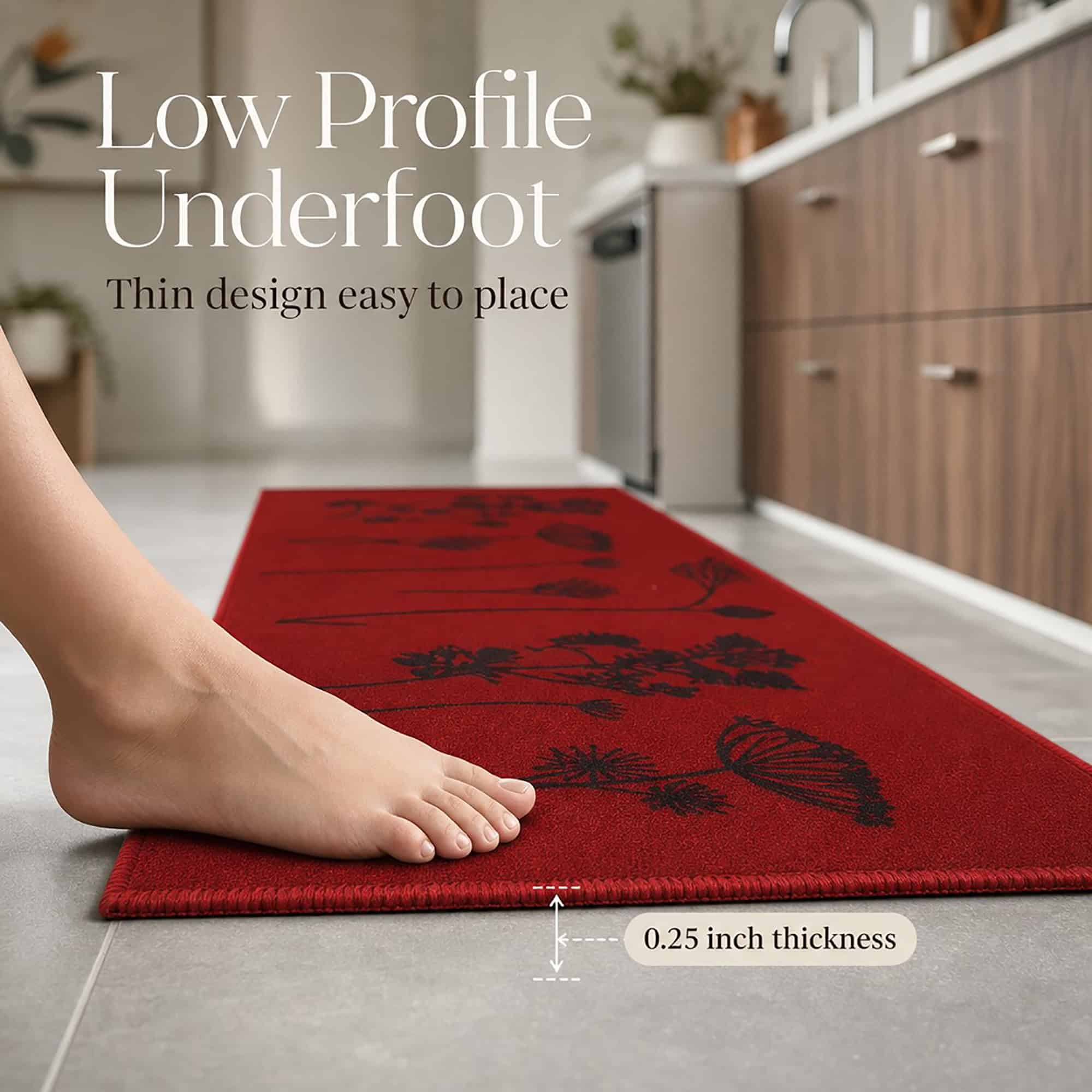 A bare foot rests on the thin red floral runner, showing a low profile of one quarter inch that sits flat and is easy to place.