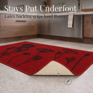 Red floral accent rug with one corner folded back to reveal the latex non slip backing that grips hard kitchen floors securely.