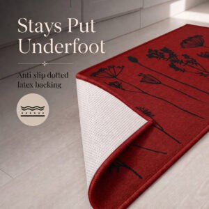 Red floral kitchen runner with one corner folded back to reveal the anti slip dotted latex backing that grips hard floors.