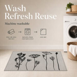 Gray floral kitchen mat in a laundry room with icons showing it can be rolled machine washed on a cold cycle and line dried.