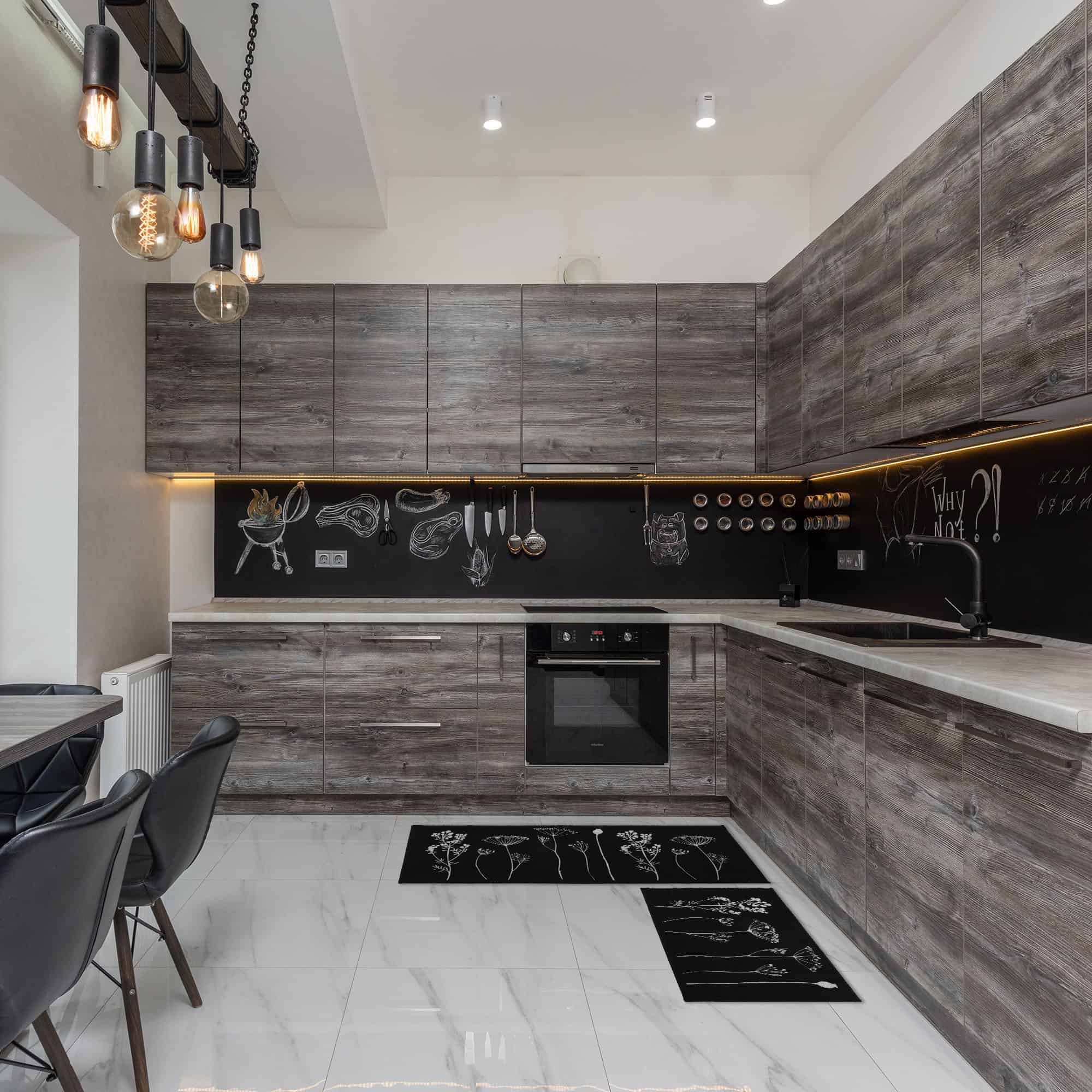 a modern black and gray kitchen and a set of black kitchen rugs with botanical motifs