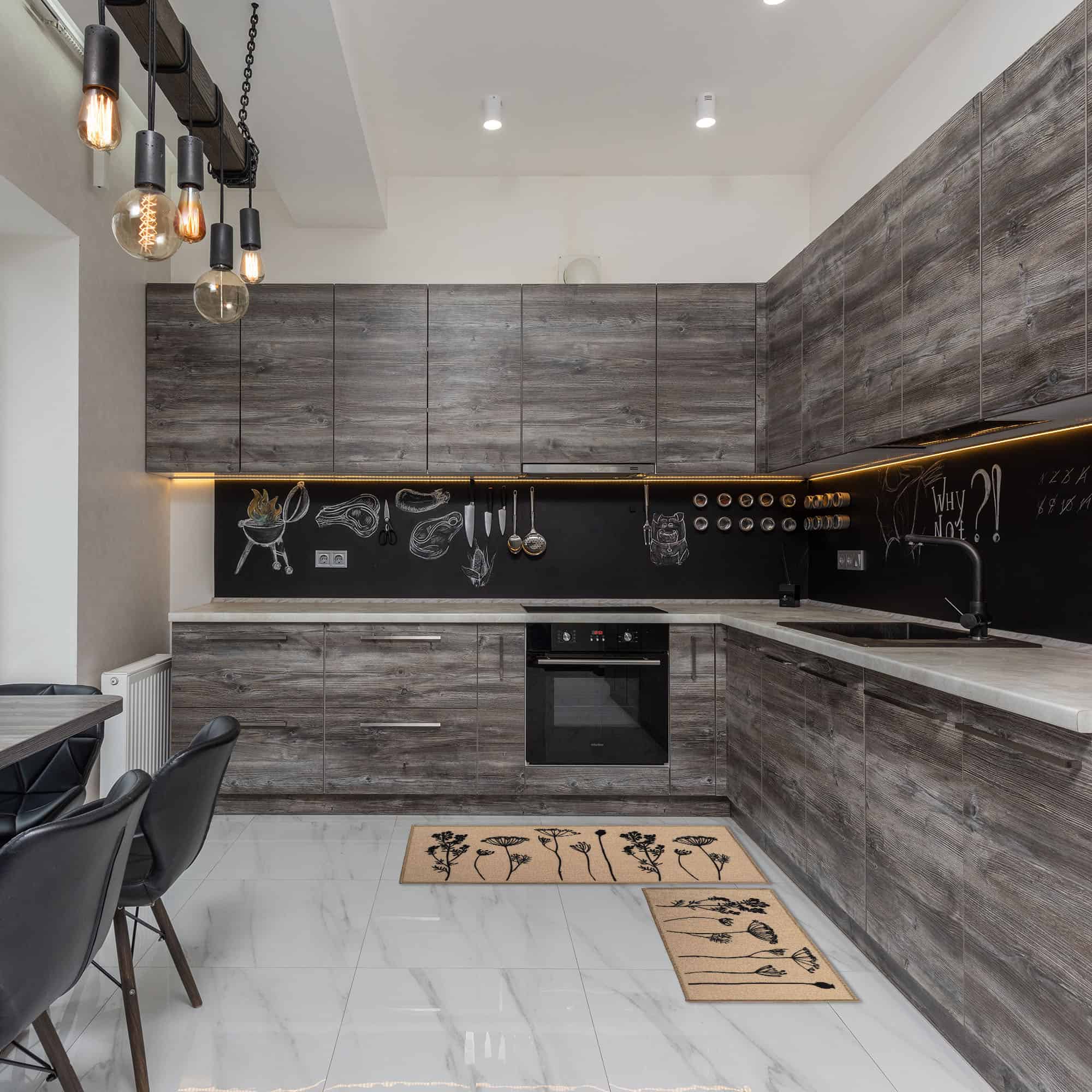 a modern black and gray kitchen and a set of beige kitchen rugs with botanical motifs