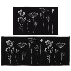 a set of black kitchen mat and runner rug with a gray wildflowers motif