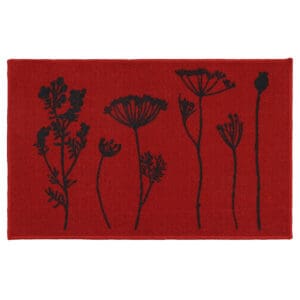 a red kitchen mat with a black wildflowers motif