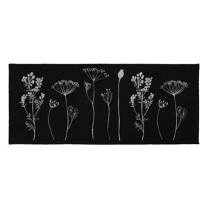 a black kitchen runner mat with a gray wildflowers motif