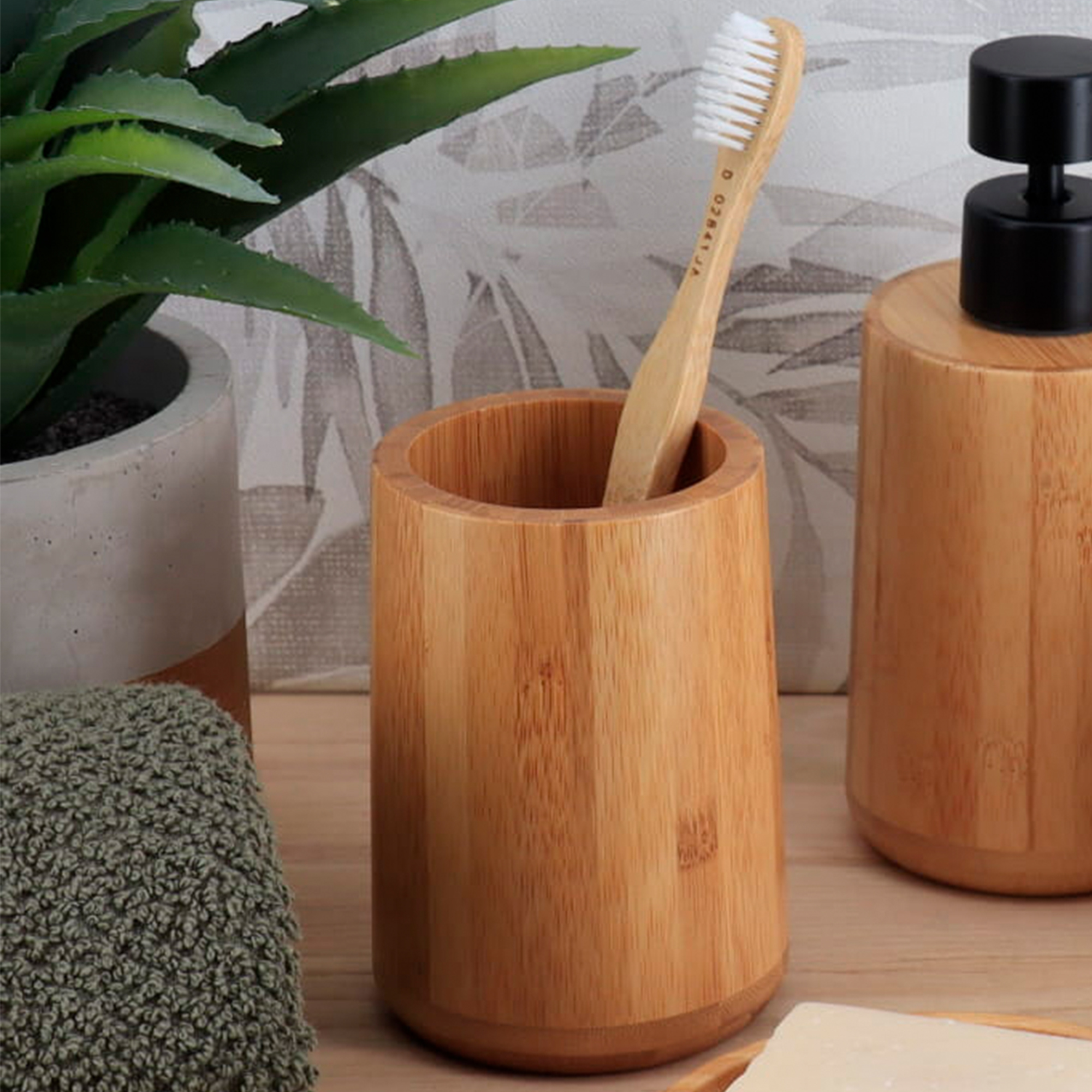 Bamboo tumbler toothbrush holder with plant and soap dispenser