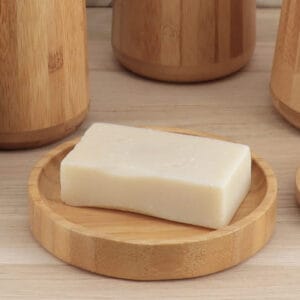 Bar soap on round bamboo soap dish close-up on vanity