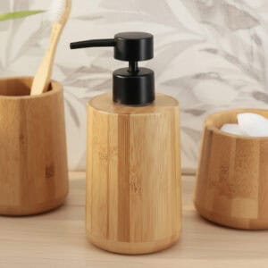 Natural bamboo soap dispenser with black pump on modern bathroom vanity