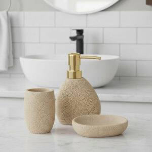 “Beige sponge-texture soap dispenser, tumbler, and soap dish on bathroom counter”