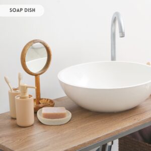Soap dish with soap bar on a bathroom countertop