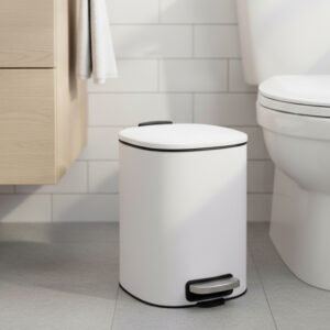 White metal step trash can placed beside toilet in bathroom
