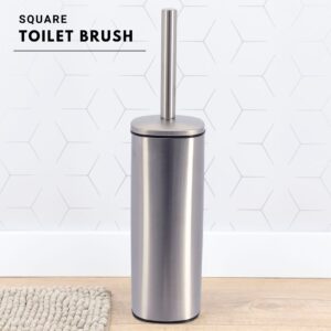 a chrome toilet brush on bathroom floor