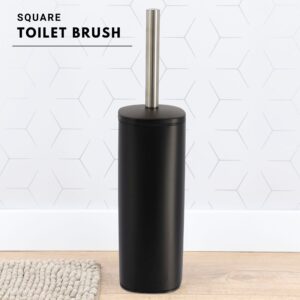 a black toilet brush on bathroom floor