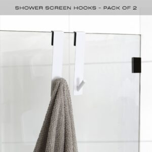 white shower door hooks on frameless door with towel hanging
