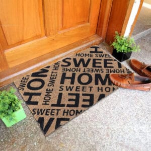 printed coco mat on the floor in front of outside door