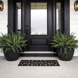 Decorative rubber entry mat on modern front porch