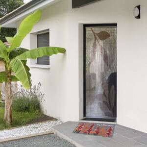 another view of entrance door with the coir doormat placed in front of the door