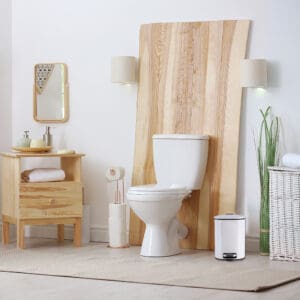 a white trash can in stylish and modern bathroom