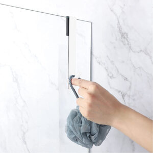 white shower hook in situation on a glass door with hand hanging bath sponge