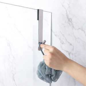 chrome shower hook in situation on a glass door with hand hanging bath sponge