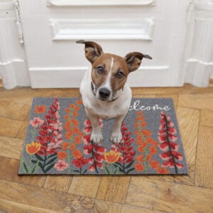 floral coir doormat with dog sitting on it