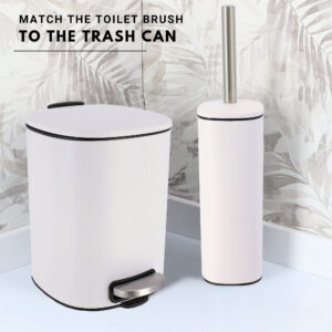 Matching white square toilet brush and step trash can set with black trim and stainless steel accents against tropical leaf wallpaper