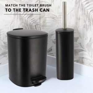 Matte black square toilet brush with stainless steel handle and matching step trash can against tropical leaf wallpaper