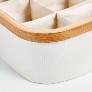 Image 7: Close-up detail of the ecru fabric 9-compartment storage basket showing the natural bamboo rim and woven fabric texture.