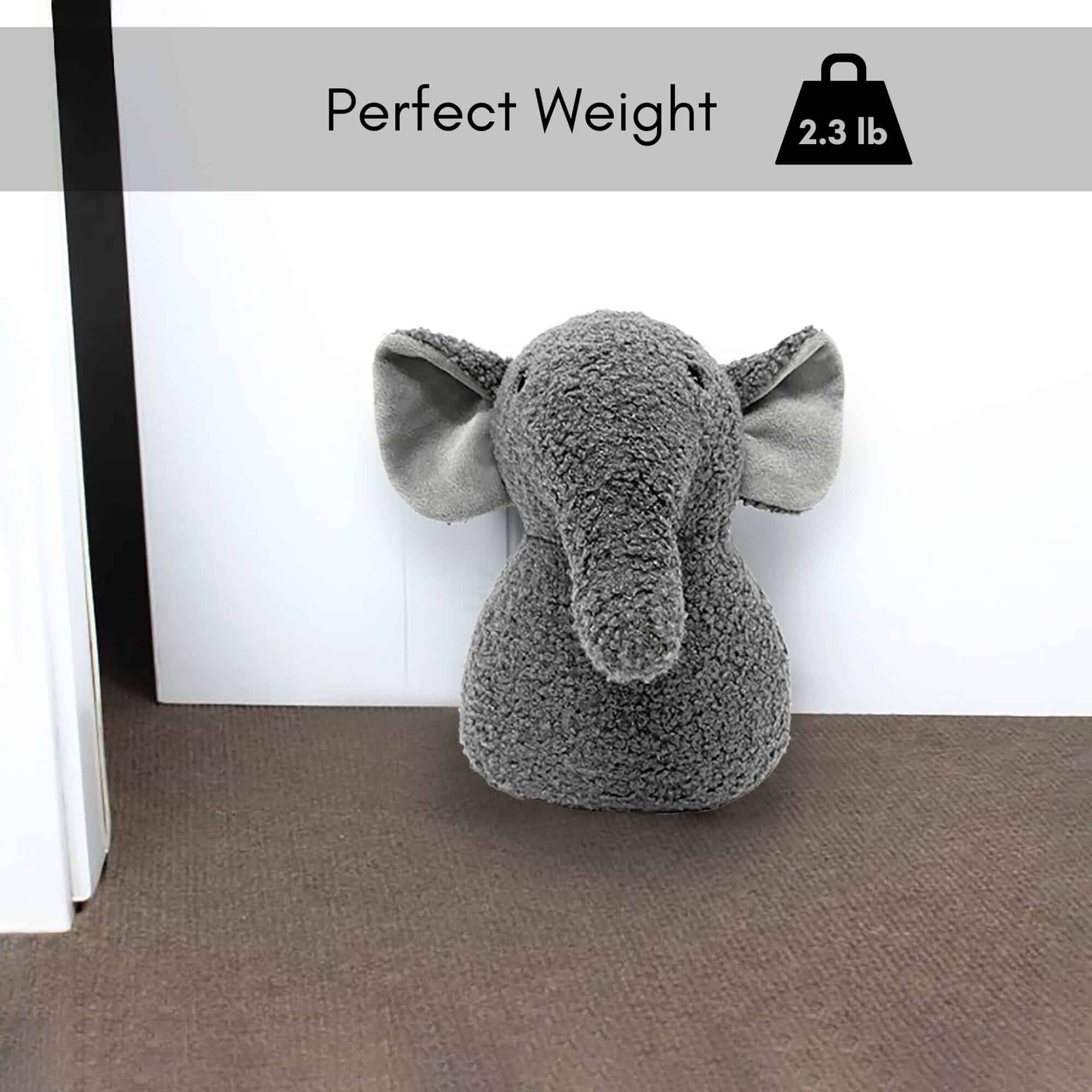 2.3 lb. elephant door stop on the floor at the bottom of the door