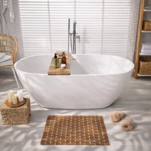 Bamboo bath mat on bathroom floor, in front of a bathtub