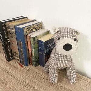 puppy doorstop in situation on a shelf holding books