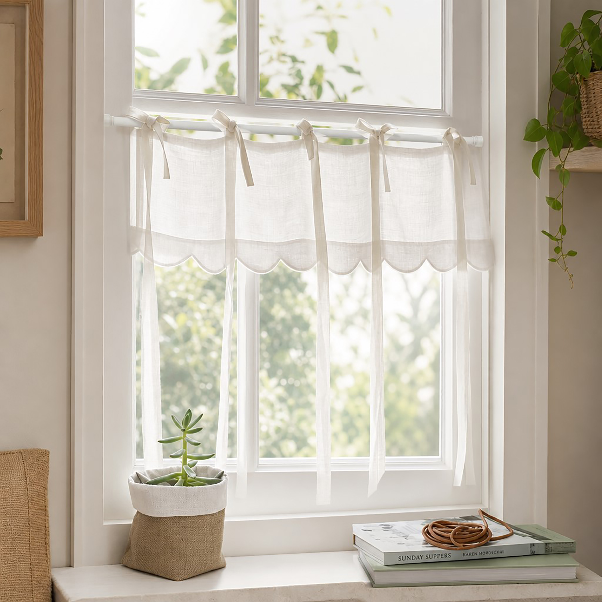 Linen tie-top curtain with scalloped edge mounted on the rod at a bright window