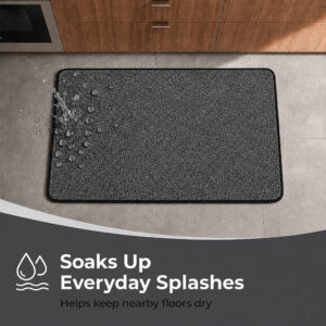 Overhead view of a charcoal grey kitchen mat catching water splashes near a counter, showing how it soaks up everyday spills and keeps floors dry.