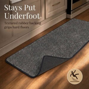 Charcoal grey kitchen runner with a corner flipped up to reveal the textured rubber backing that grips hard floors and stays put.